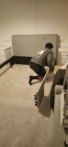 Bed frame being carefully assembled during a house move