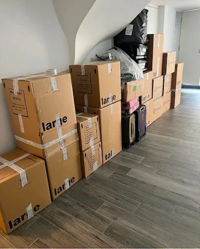 Moving boxes stacked and ready in a hallway
