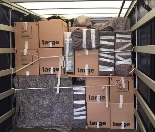 Removal van carefully packed with boxes and wrapped furniture